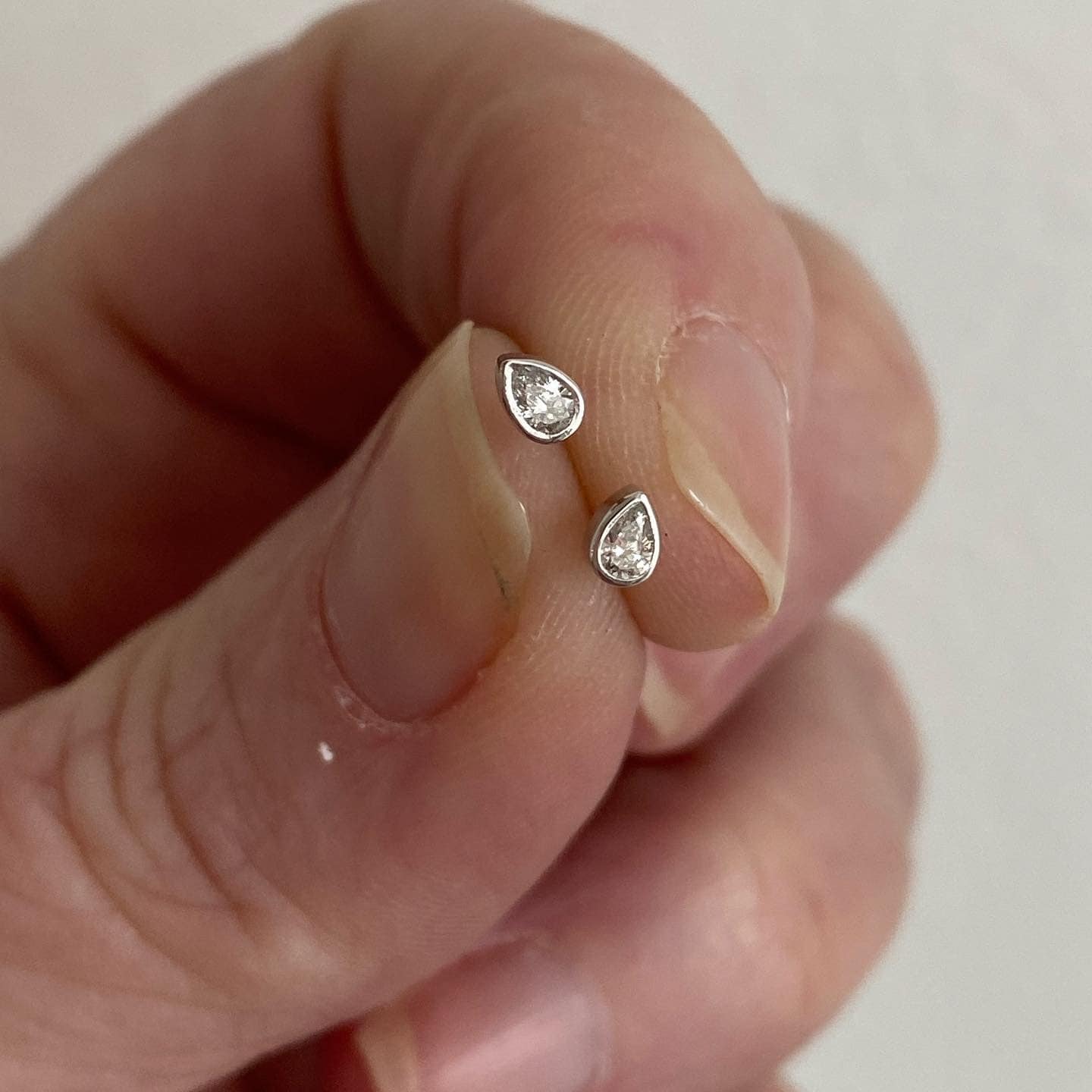 Pear Cut Diamond Stud Earrings in Solid 14K White Gold, Bezel Set, Small, Natural Diamond.
