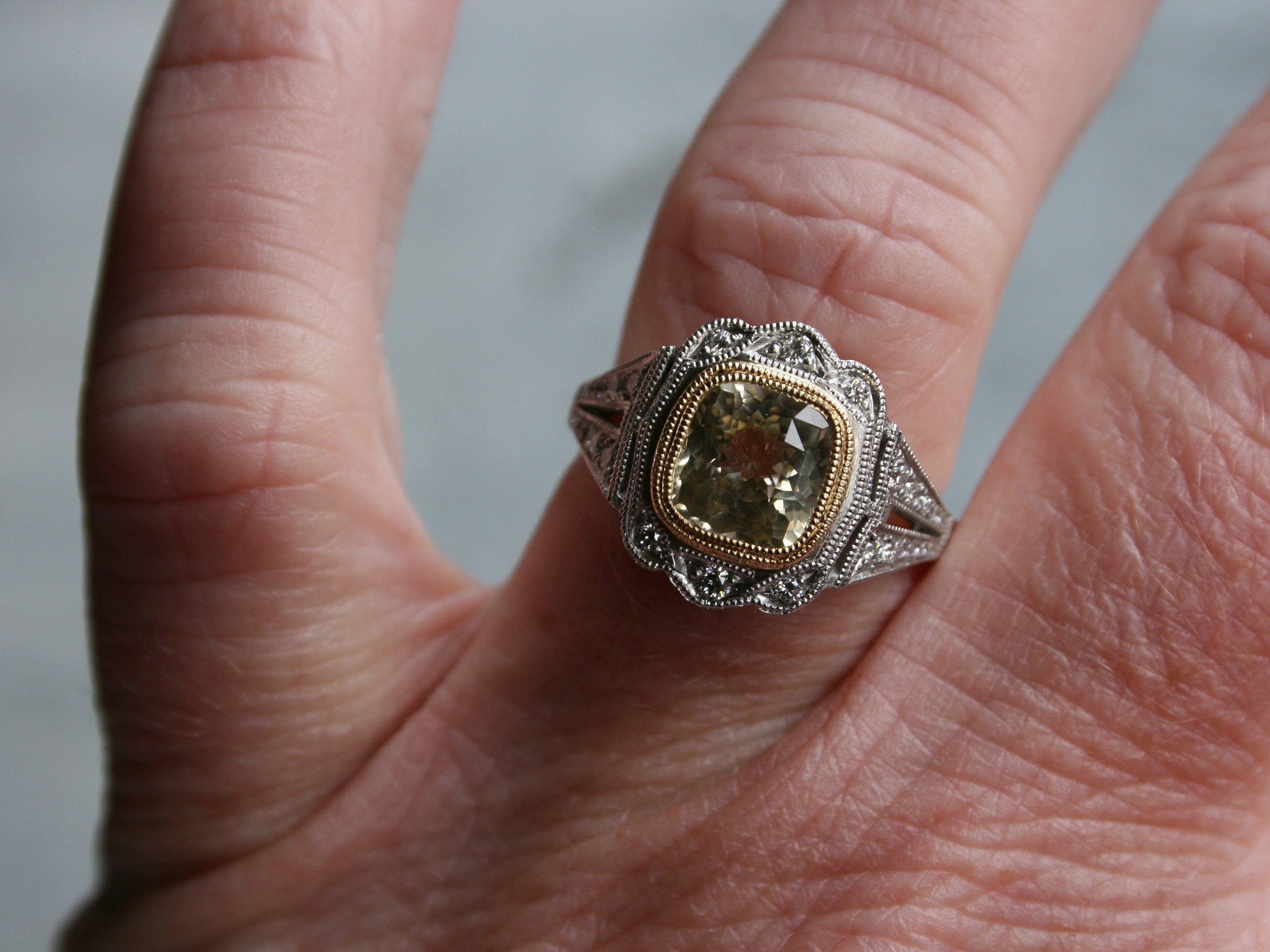 Natural Yellow Sapphire and Diamond Halo Engagement Ring in Platinum.