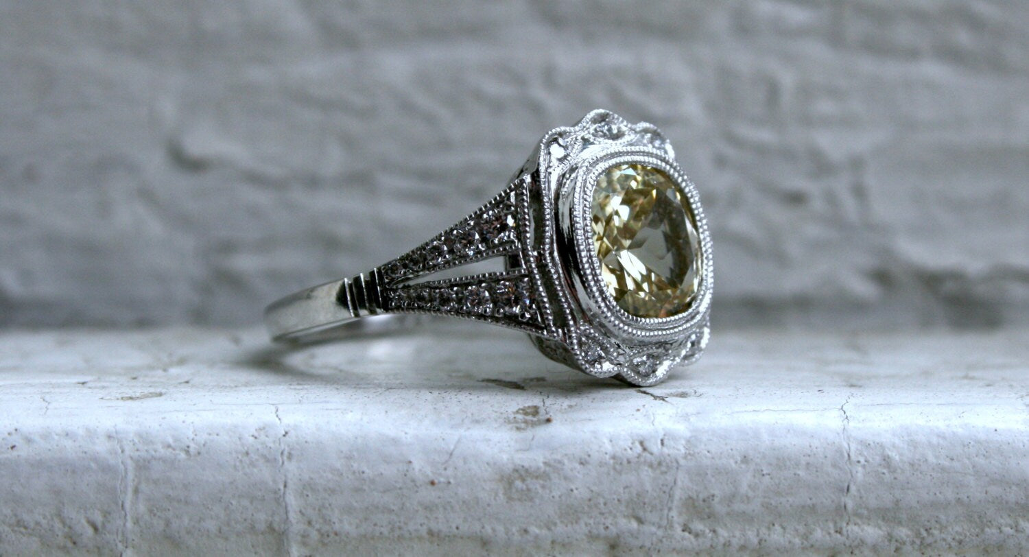 Natural Yellow Sapphire and Diamond Halo Engagement Ring in Platinum.